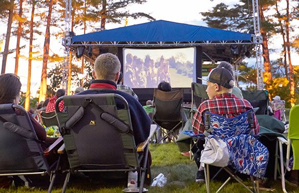 Families enjoy outdoor movie nights as part of L.L. Bean's Summer in the Park series in Freeport, Maine.
