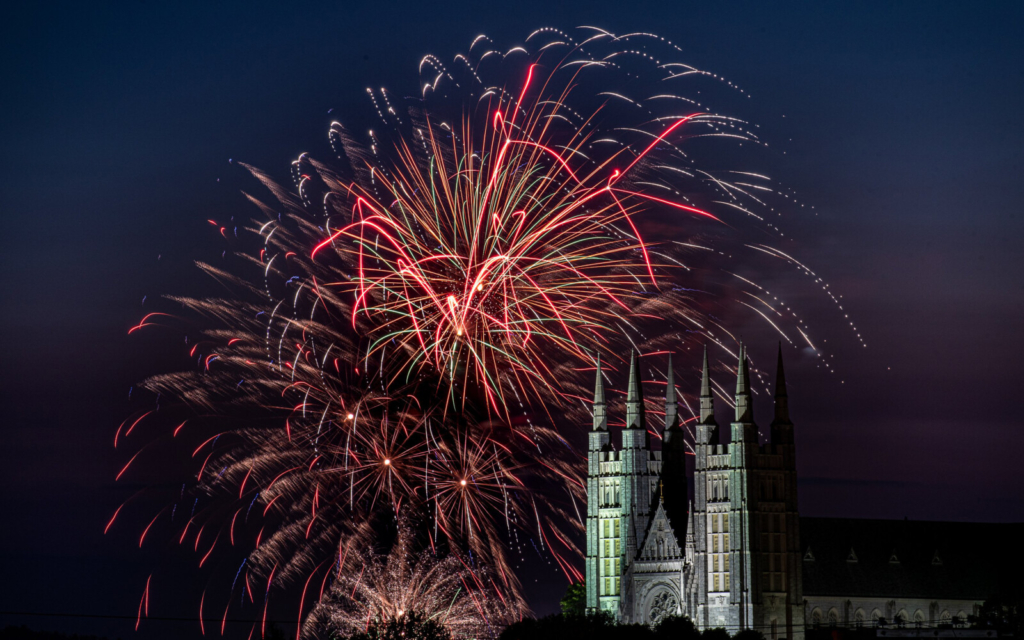Fireworks light up the night school behind the Basilica of Saints Peter and Paul in Lewiston, Maine.