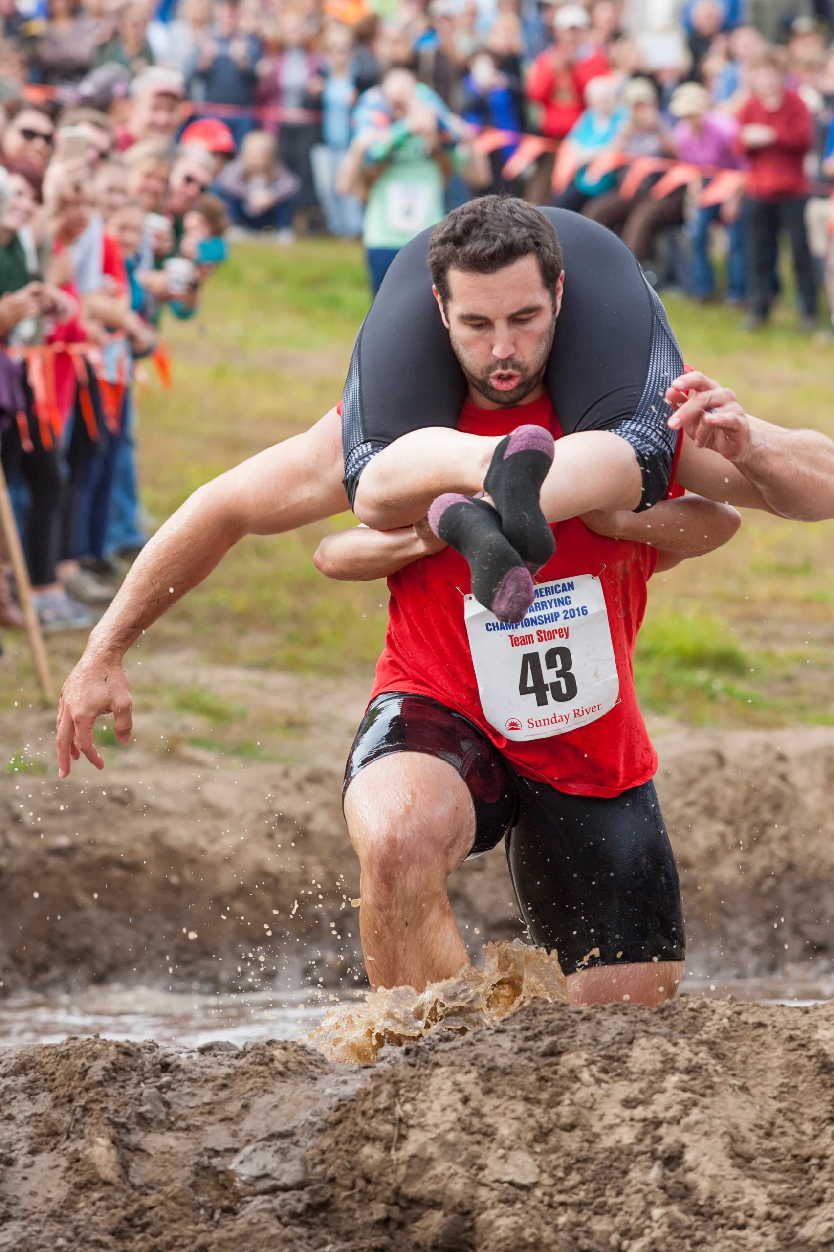 A man carrying a woman during the North American Wife Carrying Championship in Newry, Maine.