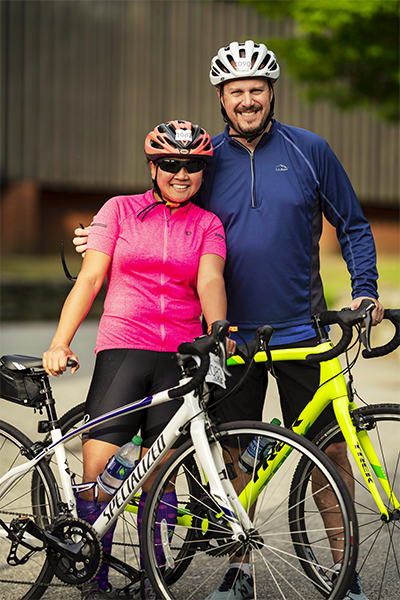 Man and women with their bicycles in full cycling gear